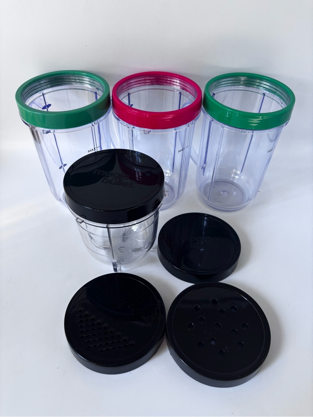 Unused Magic Bullet Accessories: 3 drinking cups with rings, 1 small jar, 4 lids
